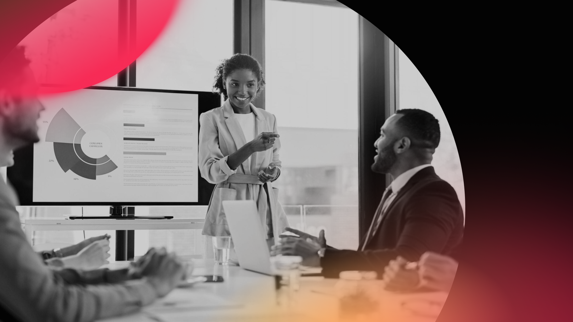 A woman stands beside a presentation screen displaying charts, addressing colleagues at a conference table in a modern office—a dynamic setting for a Digital Marketing or web design agency. The image features abstract red and yellow color overlays.