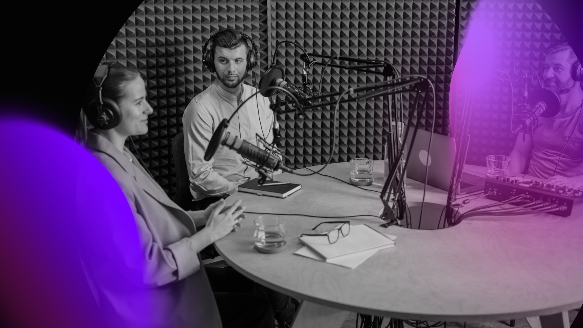 Three people wearing headphones sit around a table with microphones, recording a podcast on digital marketing in a soundproof studio. Papers, glasses, and recording equipment are visible on the table, with a purple overlay effect on the image.